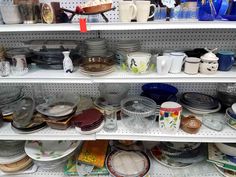 the shelves are full of dishes and cups for sale at the store or other place