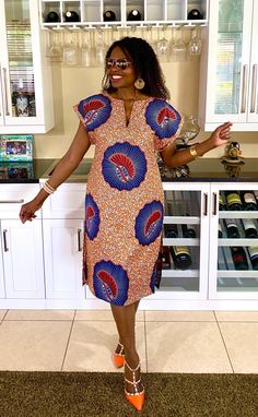 This is a unique African midi dress in multi-print Ankara clothing. This comfy dress will be made just for you from Ankara fabric cut to flatter your curves.  Style is loosely cut for wiggle room with long side slits. The fabric pictured is available. *Made to order, length is up to 40"- 42" but can be made shorter per customer request.   MEASUREMENT GUIDE: See inserted pics We are happy to answer any questions regarding measurements and styles before purchase. Note, that the customer is respons Multicolor Printed Knee-length Mini Dress, Multicolor V-neck Dress With Mixed Print, Vacation Dresses In Mixed Print, Patterned Abstract Print Short Sleeve Dresses, Multicolor Vibrant Print Knee-length Dress, Vibrant Multicolor Print Knee-length Dress, Orange Printed Short Sleeve Midi Dress, Orange Printed Midi Dress With Short Sleeves, Knee-length Patterned Printed Dresses