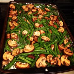 green beans and mushrooms in a pan on the stove