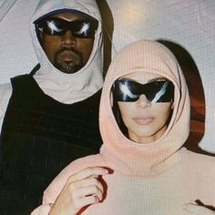 the man and woman are wearing sunglasses on their heads