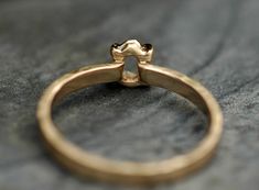 a close up of a gold ring on a surface with the middle part of the ring showing