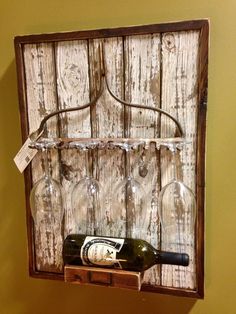 a wine bottle and glass holder hanging on a wall