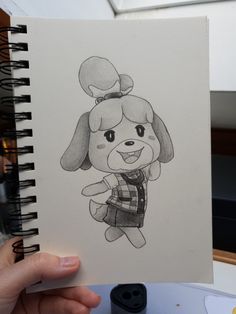 a person holding up a drawing of a dog