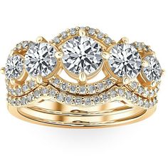 three stone wedding ring set in yellow gold with diamonds on each band and center stone