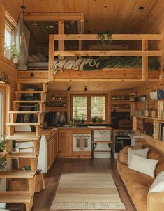 the interior of a tiny cabin with wood paneling and stairs leading up to the loft