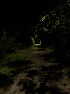 an empty road at night with the light on and no one in it or someone out