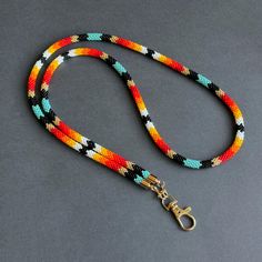 Elevate your style with this Native-inspired teacher lanyard. Handmade Southwestern beaded lanyard, perfect for holding ID cards, keys, and badges with elegance. ☑️ **Stylish and Functional Design**   This Native-inspired teacher lanyard blends style and utility. Its colorful beadwork complements any outfit while securely holding ID cards, keys, or badges. - Native-inspired beads in vibrant colors   - Secure clasp for easy attachment of essentials   - Versatile for both classroom and office use Southwestern Aesthetic, Badges Design, Beaded Lanyard, Teacher Lanyard, Beaded Lanyards, Beaded Rope, Eyeglass Holder, Stylish Gifts, Badge Holders Lanyard