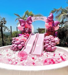 an inflatable pool with pink and purple decorations