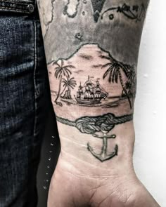 a man's arm with an anchor and ship on it