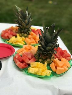 pineapples, watermelon and other fruit are on plates