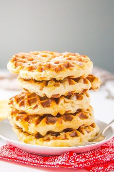 three waffles stacked on top of each other on a plate with a fork