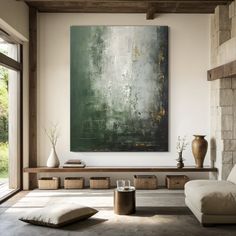 a living room filled with furniture and a large painting on the wall over a fireplace