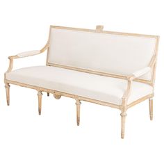 a white couch sitting on top of a wooden frame