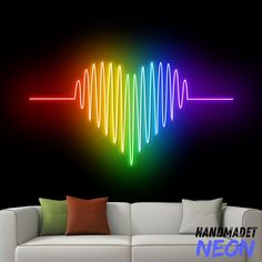 a living room with a white couch and colorful sound wave wall decal