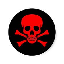 a red skull and crossbones sticker on a black circle with white background