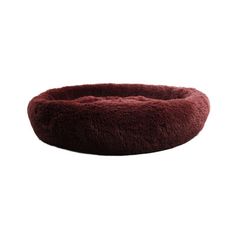 a round dog bed with a red fuzzy material on the top and bottom, sitting in front of a white background