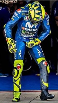 a man in blue and yellow motorcycle suit