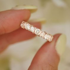 a close up of a person holding a ring