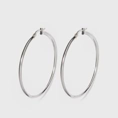 Spruce up your everyday look with these high-fashion sterling silver hoop earrings. With a silver finish, these medium hoop earrings give you endless styling options, complementing everything from your comfiest tees to sheath dresses and more. Complete your look with layered silver-finished necklaces or a chunky chain link bracelet for a chic, coordinated look. Gender: female. Age Group: adult. Pattern: Solid. Classic Metal Hoop Earrings For Everyday, Trendy Hypoallergenic White Gold Hoop Earrings, Iconic Brunettes, Silver Hoop Earrings Medium, Clean Silver Jewelry, Silver Hoop Earring, Earring Stack, Simple Hoop Earrings, Medium Hoop Earrings