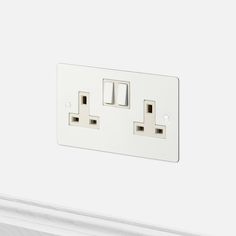 an electrical outlet with two white outlets