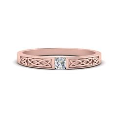 a pink gold wedding ring with a princess cut diamond in the center and an intricate band