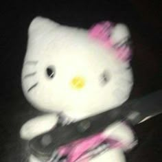 a hello kitty stuffed animal holding a knife