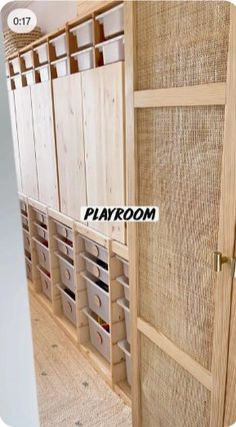 a room with wooden shelves and baskets on the wall, next to a carpeted floor