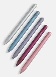 four different colored pens sitting next to each other