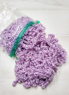 Curly yarn hair in beautiful Orchid Lavender. NOT just for dolls, look at the pictures showing a beautiful heart made from a coat hanger and the curly yarn. Picture courtesy of Freida. This listing is for one zip lock bag of curly yarn doll hair, this bag weighs approx. 2 ounces. This acrylic yarn is washed and oven dried around rods to give the stunning and lasting effect of ringlets. Great for hair on a wide variety of dolls. The dolls pictured are for photographic purposes only. From a smoke Yarn Doll Hair, Curly Yarn Hair For Dolls, Lavender Weave, Rapunzel Yarn Wig, Rapunzel Wig Yarn, Lavender Dolls Handmade, Hair Yarn, Zip Lock Bag, Yarn Hair