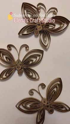 three metal butterflies on a white surface with the words,'butterfly craft studio '