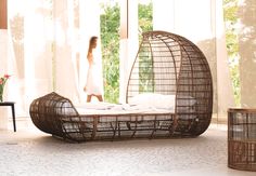 a wicker bed in the middle of a room