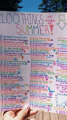 someone holding up a handwritten summer checklist