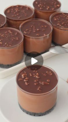 chocolate desserts are arranged in rows on a white platter and placed next to each other