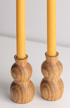 two wooden candlesticks sitting next to each other