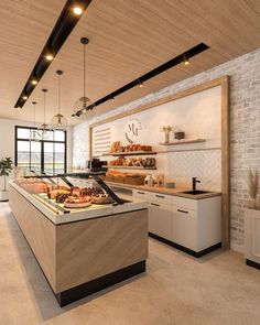 a bakery with lots of breads and pastries on display in front of the counter