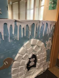 the penguin is coming out of the hole in the ice sheet art project with snow and icing on it