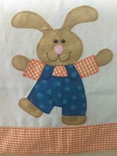 a close up of a stuffed animal on a table cloth with an orange and white checkered border