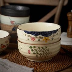 three bowls sitting on top of a wooden table