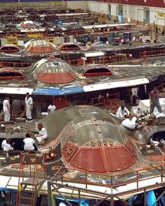 workers are working on the assembly line at an aircraft factory