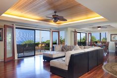 a living room filled with furniture next to sliding glass doors and a wooden flooring area