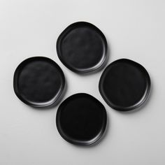 three black plates sitting on top of each other