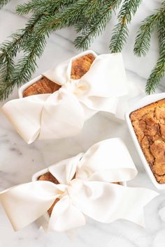 two small white dishes filled with baked goods