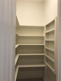 an empty walk in closet with shelves and no door to the other room or bathroom