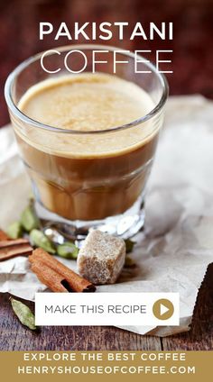 a cup of coffee on top of a table next to cinnamons and anise