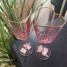 two wine glasses sitting next to each other on a table