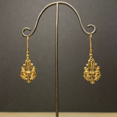 Here is a pair of cute, little, very light ornate dangle earrings.  These were actually made in the early seventies. They are good quality, new (unused) vintage items, made of gold plated brass. 13mm wide x 36mm high (with earwire) BOX06 IMPORTANT: please note that I offer different earwires as seen in second picture, and the price of the earrings vary depending on the chosen earwires.  It goes as follows: A: gold plated base metal french wires with ball (rubber stoppers included).  B: gold plat Gold Plated Filigree Teardrop Jewelry, Teardrop-shaped Gold Plated Filigree Jewelry, Victorian Gold Plug Earrings, Metal Pendant Earrings For Wedding, Gold-tone Dangle Clip-on Earrings, Metal Dangle Earrings With Ear Wire, Gold-tone Metal Earrings For Wedding, Ornate Bronze Earrings, Dangle Metal Earrings With Ear Wire