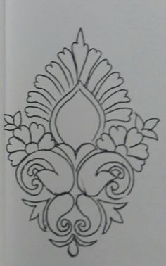 an intricately designed piece of paper on a white surface with black ink in the middle