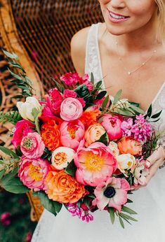 a woman holding a bouquet of flowers in her hands