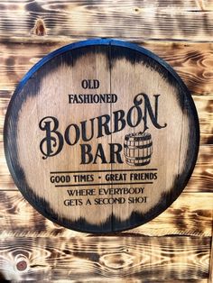 an old fashioned bourbon bar sign hanging on a wooden wall