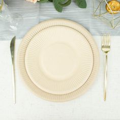 a table setting with plates, silverware and flowers